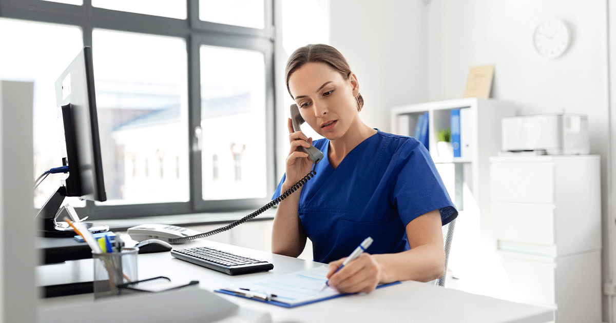 AdobeStock_353578861 A healthcare professional speaking on the phone while reviewing patient information, ready to answer questions and provide compassionate guidance about medical abortion, pregnancy testing, and ultrasound services.
